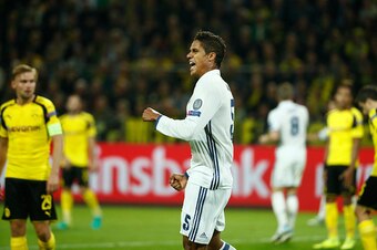 Real Madrid's French defender Raphael Varane (c) reacts after scoring during the UEFA Champions League first leg football match between Borussia Dortmund and Real Madrid at BVB stadium in Dortmund, on September 27, 2016. / AFP / Odd ANDERSEN        (Photo