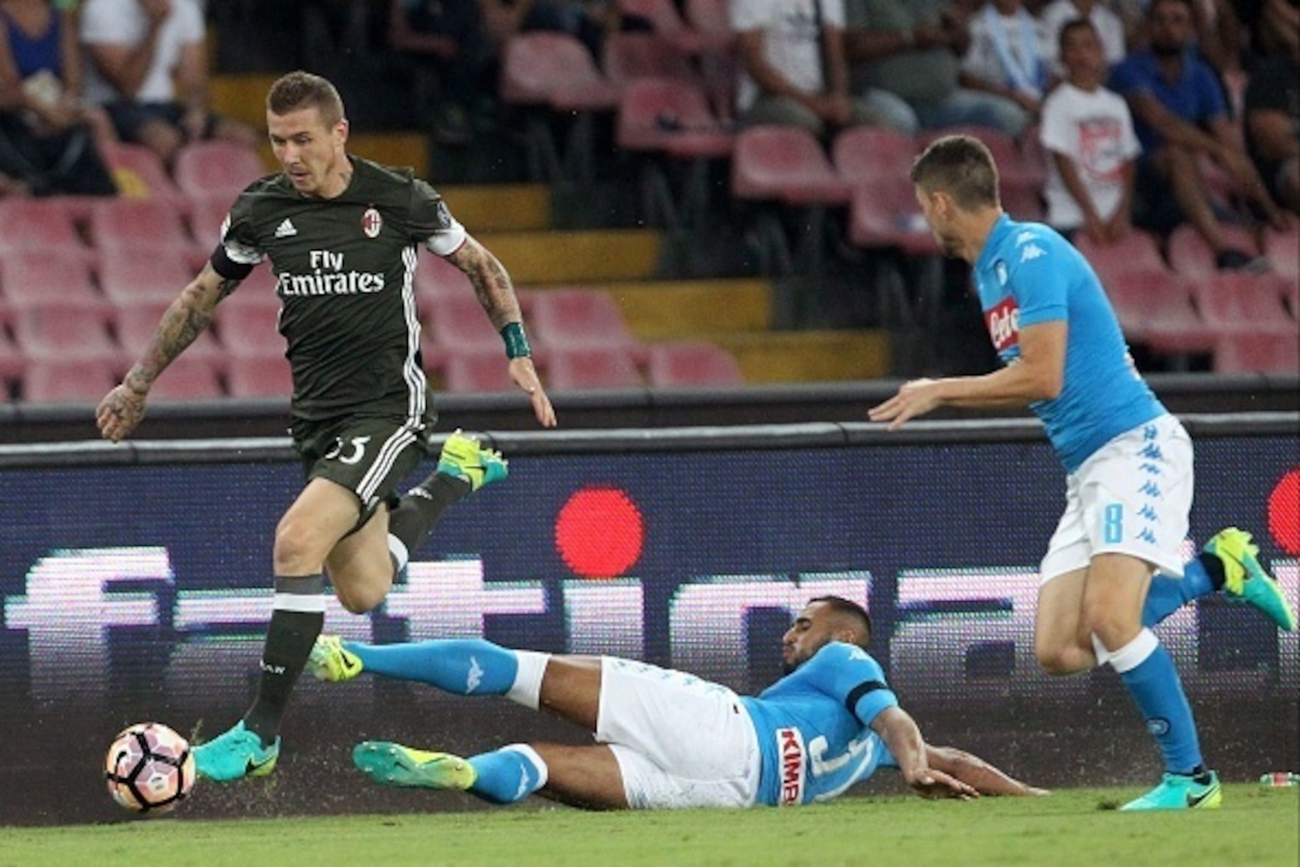 Milan's midfielder from Slovakia Juraj Kucka (L) drives the ball with Napoli's defender from Algeria Faouzi Ghoulam (C) and Napoli's midfielder from Italy Jorginho (R) during the Italian Serie A football match SSC Napoli vs AC Milan on August 27 2016 at t