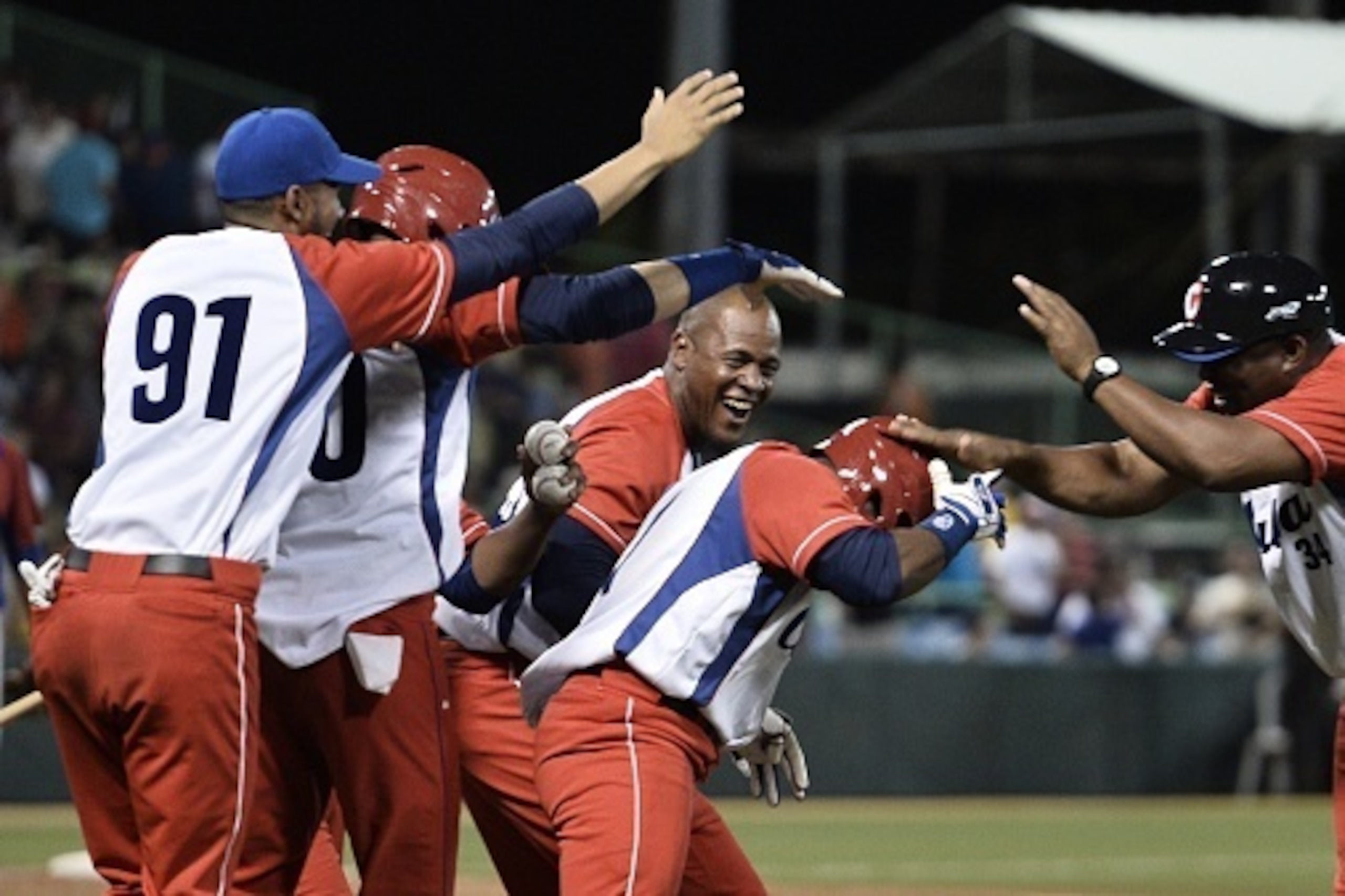 Yunielki Lourdes Gurriel #91 of Cuba and teammates celebrate their 10th inning 3-2 victory over Puerto Rico in the San Juan Serie Del Caribe on February 4, 2015 in San Juan, Puerto Rico.        AFP PHOTO / PAUL J. RICHARDS        (Photo credit should read