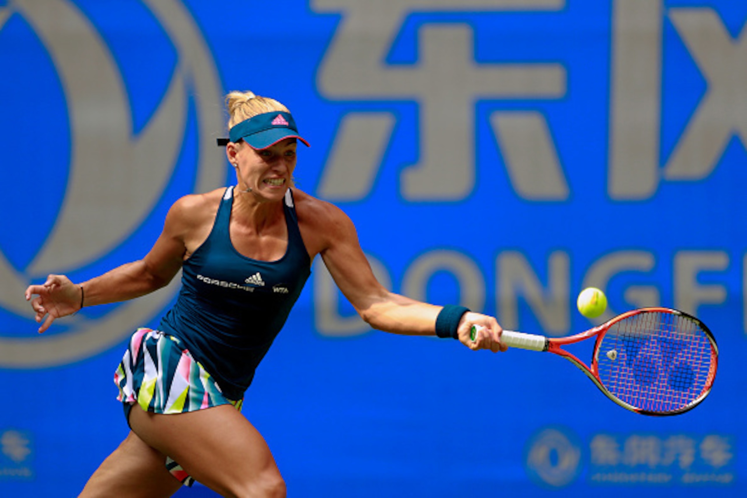 WUHAN, CHINA - SEPTEMBER 27: Angelique Kerber of Germany returns a shot to Kristina Mladenovic of France during their third round match on Day three of the 2016 Dongfeng Motor Wuhan Open at the Optics Valley International Tennis Center on September 27, 20