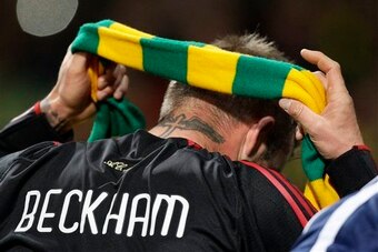 Beckham wears the green and gold protest scarf.