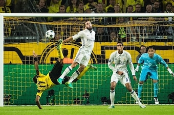 Dortmund's Gabonese forward Pierre-Emerick Aubameyang (L) and Real Madrid's defender Dani Carvajal (2ndL) vie for the ball watched by Real Madrid's French defender Raphael Varane (2ndR) and Real Madrid's Costa Rican goalkeeper Keylor Navas (R) during the 