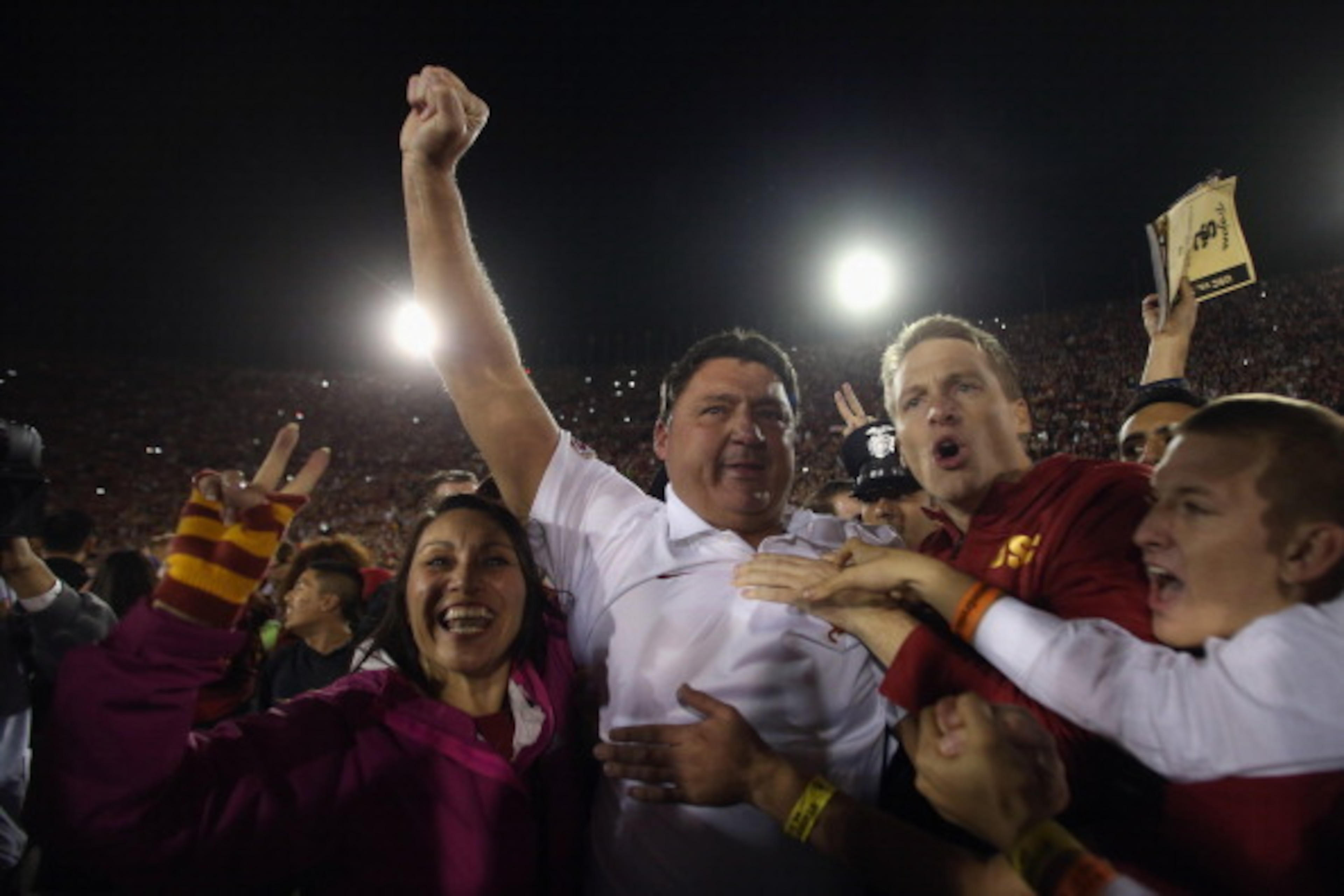 LOS ANGELES, CA - NOVEMBER 16:  USC Trojans interim head coach Ed Orgeron celebrates the Trojans' 20-17 victory over the Stanford Cardinal with fans at Los Angeles Coliseum on November 16, 2013 in Los Angeles, California.  (Photo by Jeff Gross/Getty Image
