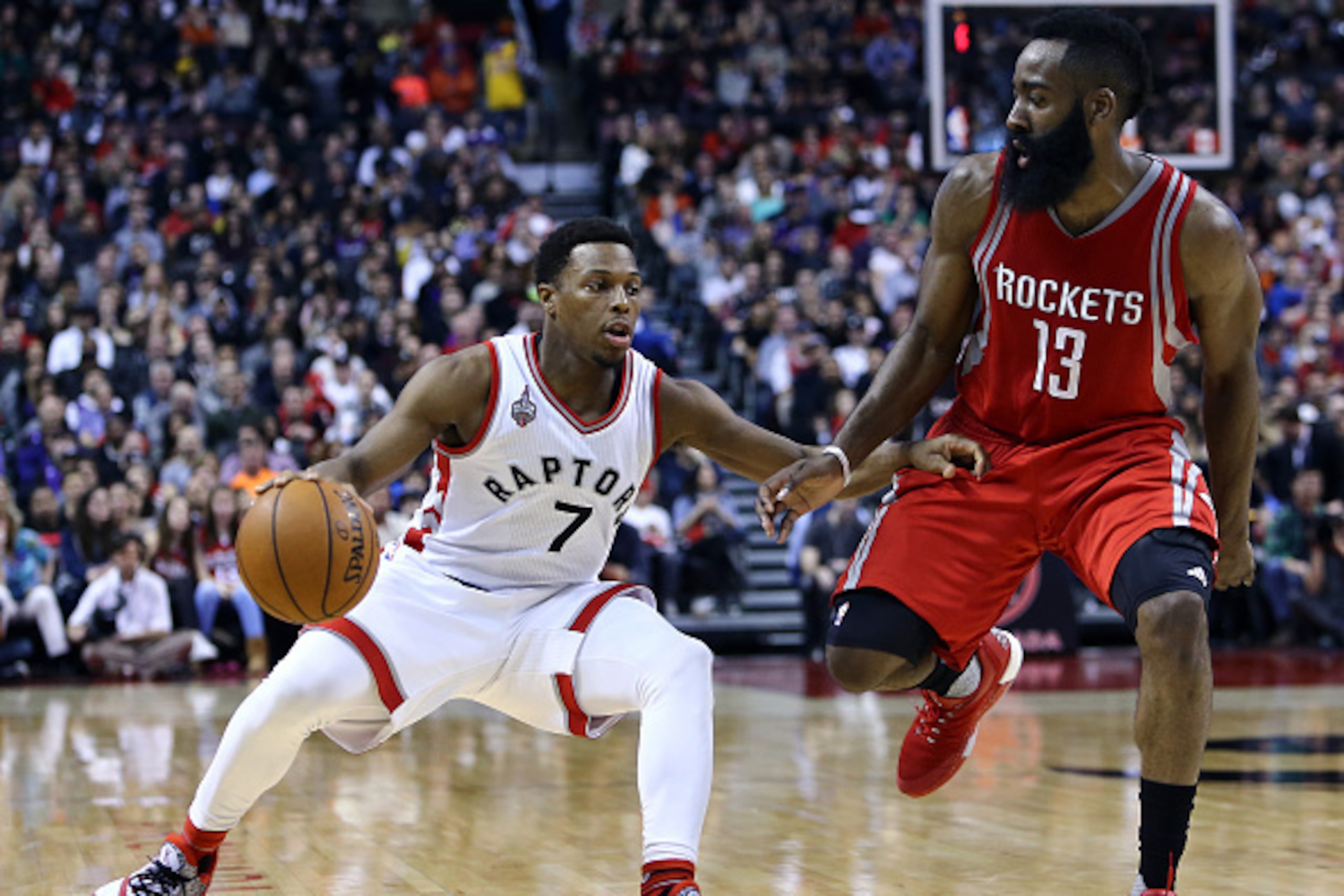 TORONTO, ON - MARCH 06:  Kyle Lowry #7 of the Toronto Raptors dribbles the ball as James Harden #13 of the Houston Rockets defends during the second half of an NBA game at the Air Canada Centre on March 06, 2016 in Toronto, Ontario, Canada.  NOTE TO USER: