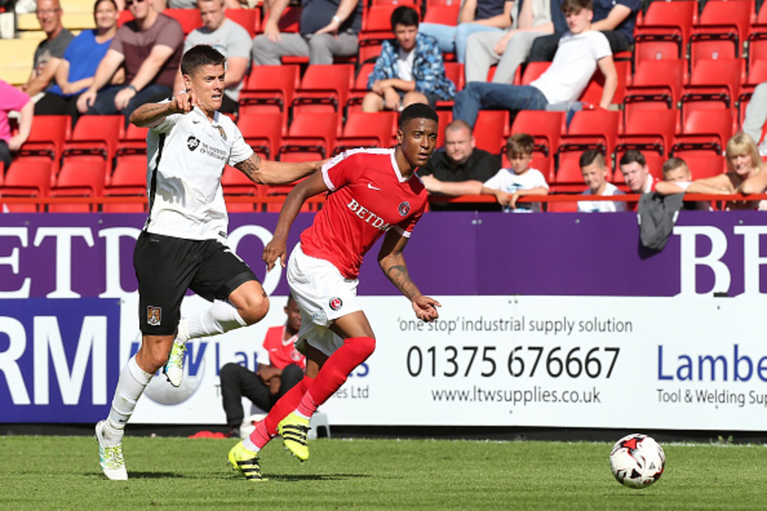LONDON, ENGLAND - AUGUST 13:  Ezri Konsa of Charlton Athletic looks to the ball with Alex Revell of Northampton Town during the Sky Bet League One match between Charlton Athletic and Northampton Town at The Valley on August 13, 2016 in London, England.  (