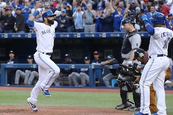 TORONTO, CANADA - SEPTEMBER 24: Jose Bautista #19 of the Toronto Blue Jays celebrates his three-run home run with Edwin Encarnacion #10 in the eighth inning during MLB game action against the New York Yankees on September 24, 2016 at Rogers Centre in Toro