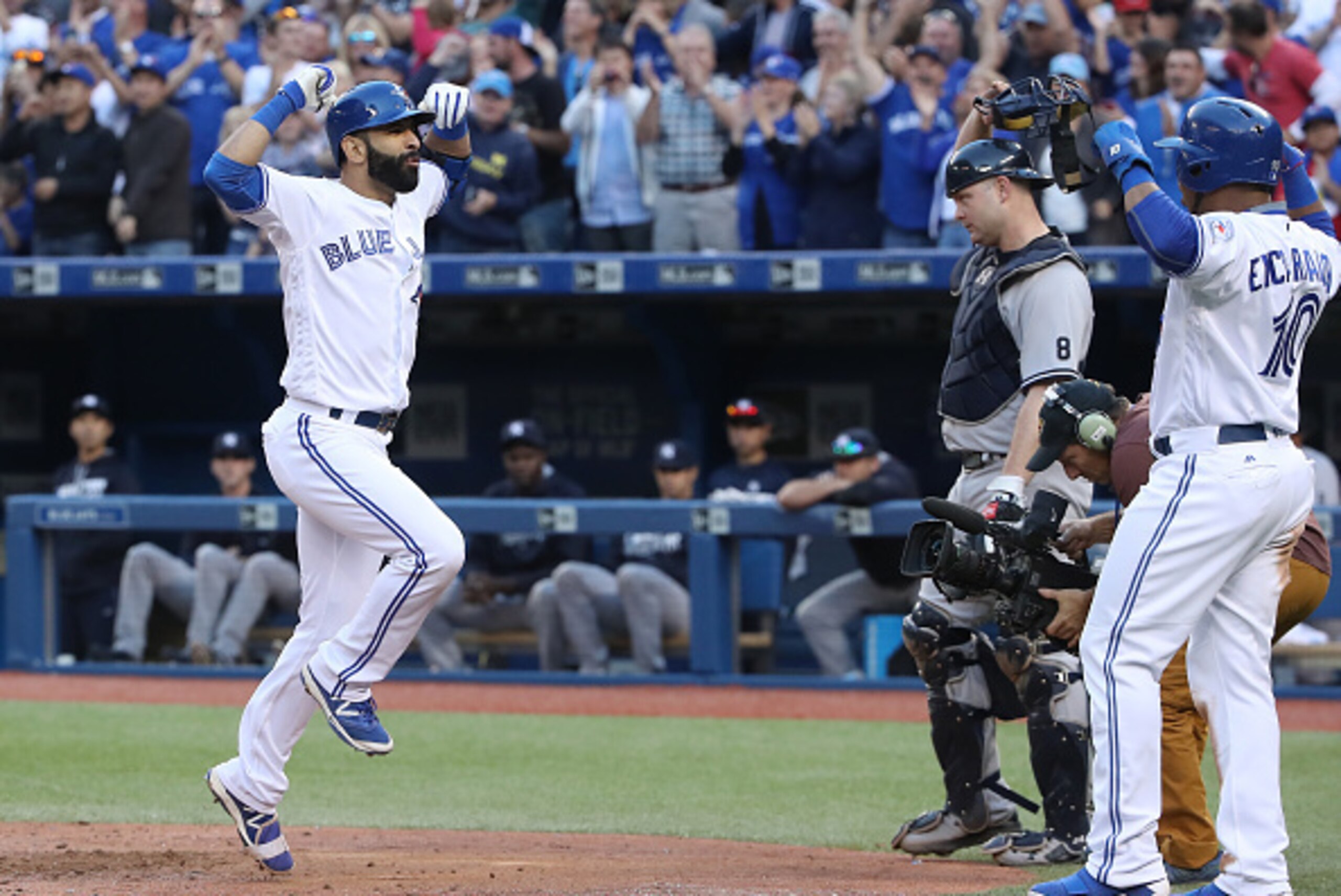 TORONTO, CANADA - SEPTEMBER 24: Jose Bautista #19 of the Toronto Blue Jays celebrates his three-run home run with Edwin Encarnacion #10 in the eighth inning during MLB game action against the New York Yankees on September 24, 2016 at Rogers Centre in Toro