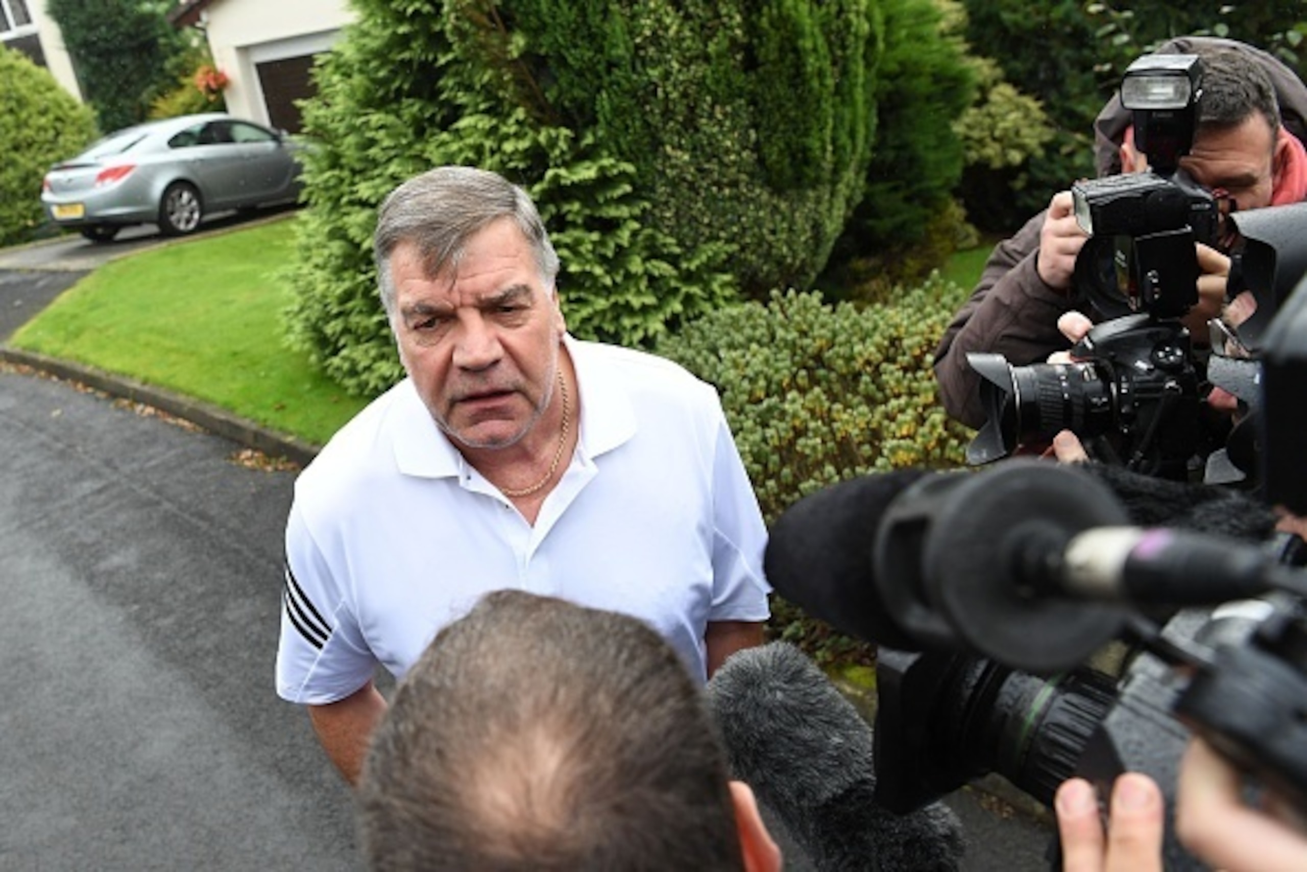 TOPSHOT - Former England national football team manager Sam Allardyce speaks to the press outside his home in Bolton on September 28, 2016.
Sam Allardyce's reign as England manager came to a humiliating end yesterday as he departed after just 67 days in c