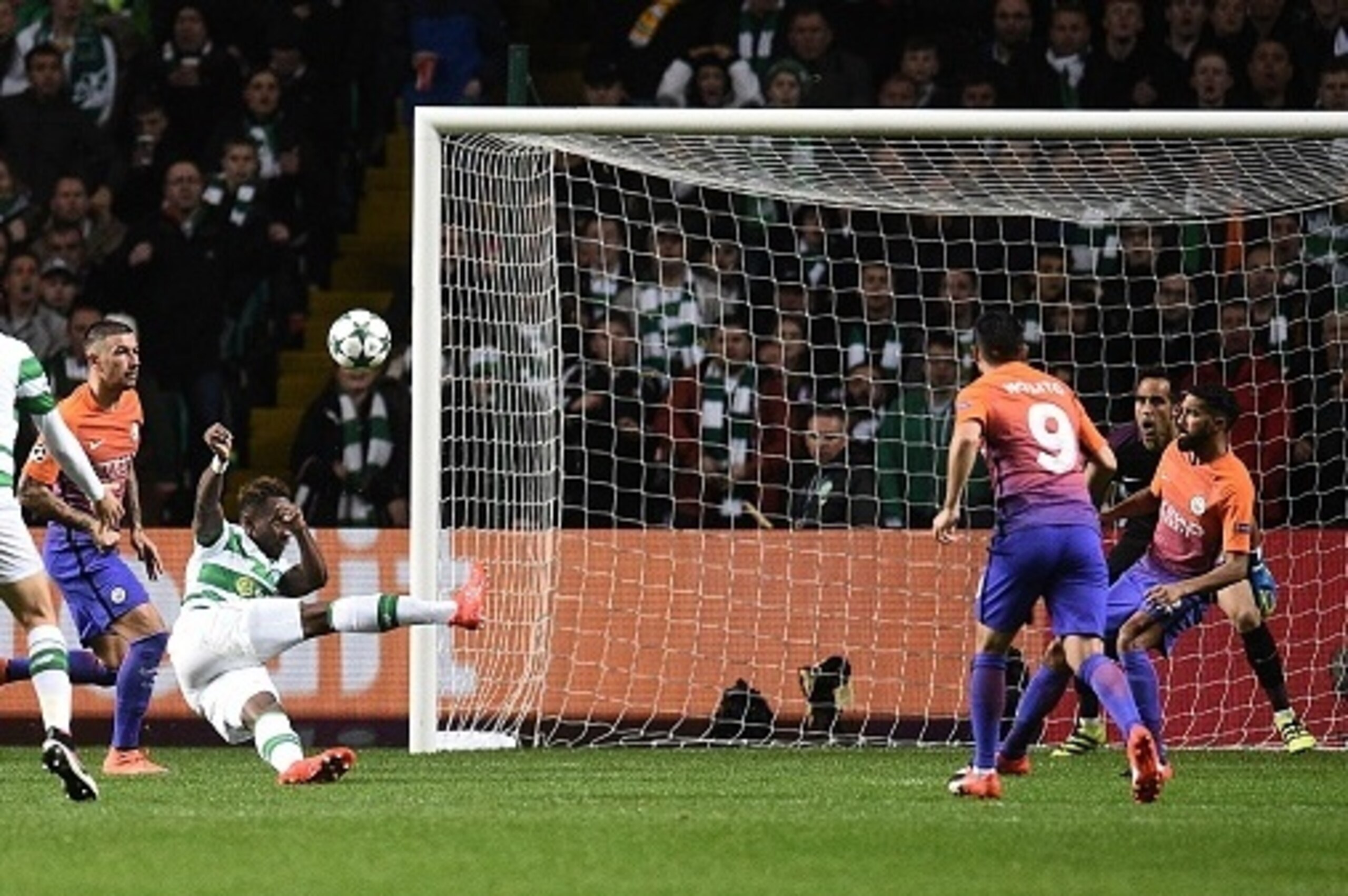 Manchester City's Serbian defender Aleksandar Kolarov (2L) and Manchester City's Chilean goalkeeper Claudio Bravo (2R) watch as Celtic's French striker Moussa Dembele (3L) scores his team's thrid goal during the UEFA Champions League Group C football matc