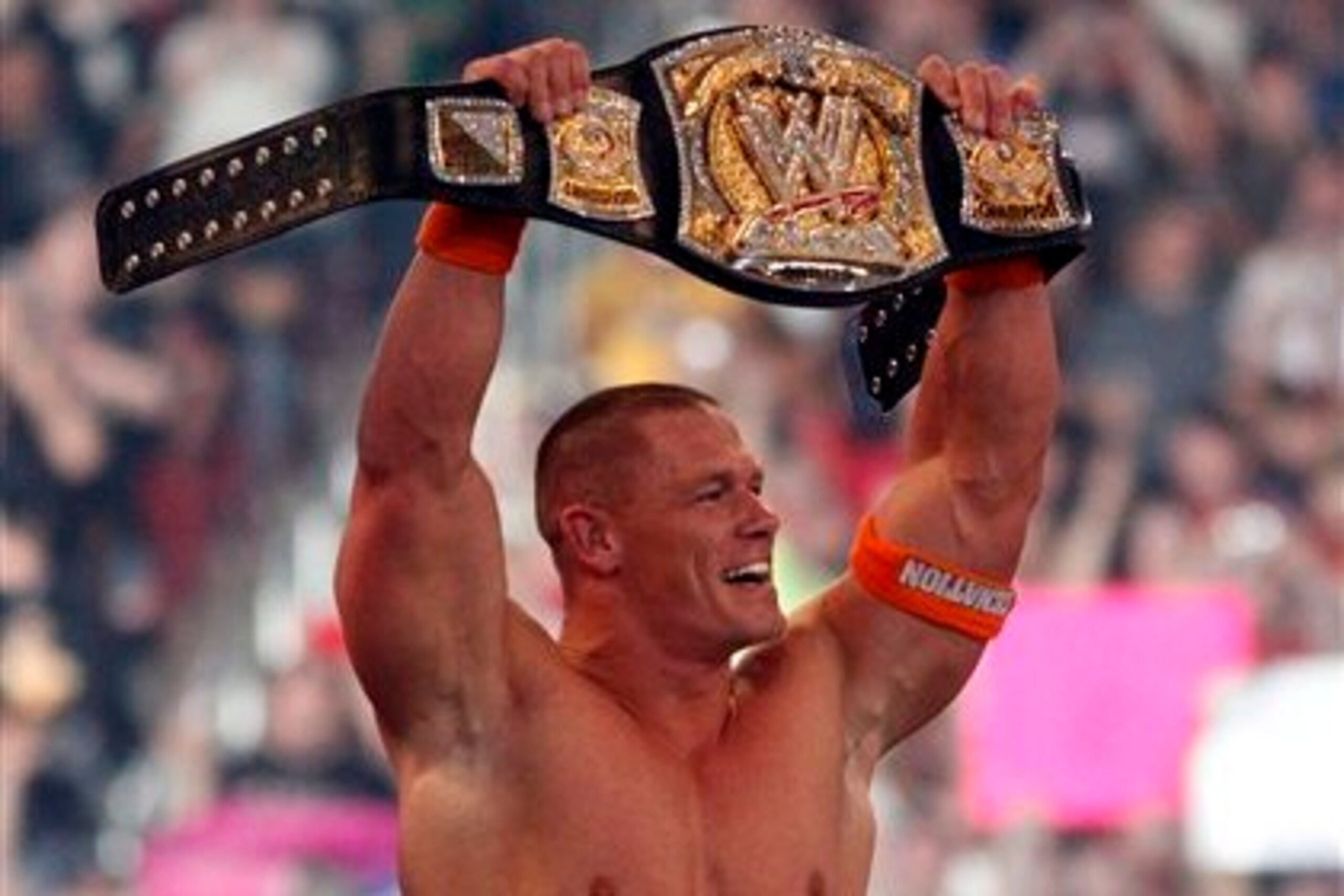 John Cena showing off the WWE title.