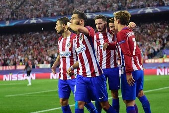 Atletico Madrid's Belgian midfielder Yannick Ferreira Carrasco (2ndL) celebrates with teammates after scoring during the UEFA Champions League Group D football match Club Atletico de Madrid vs FC Bayern Munich at the Vicente Calderon stadium in Madrid on 