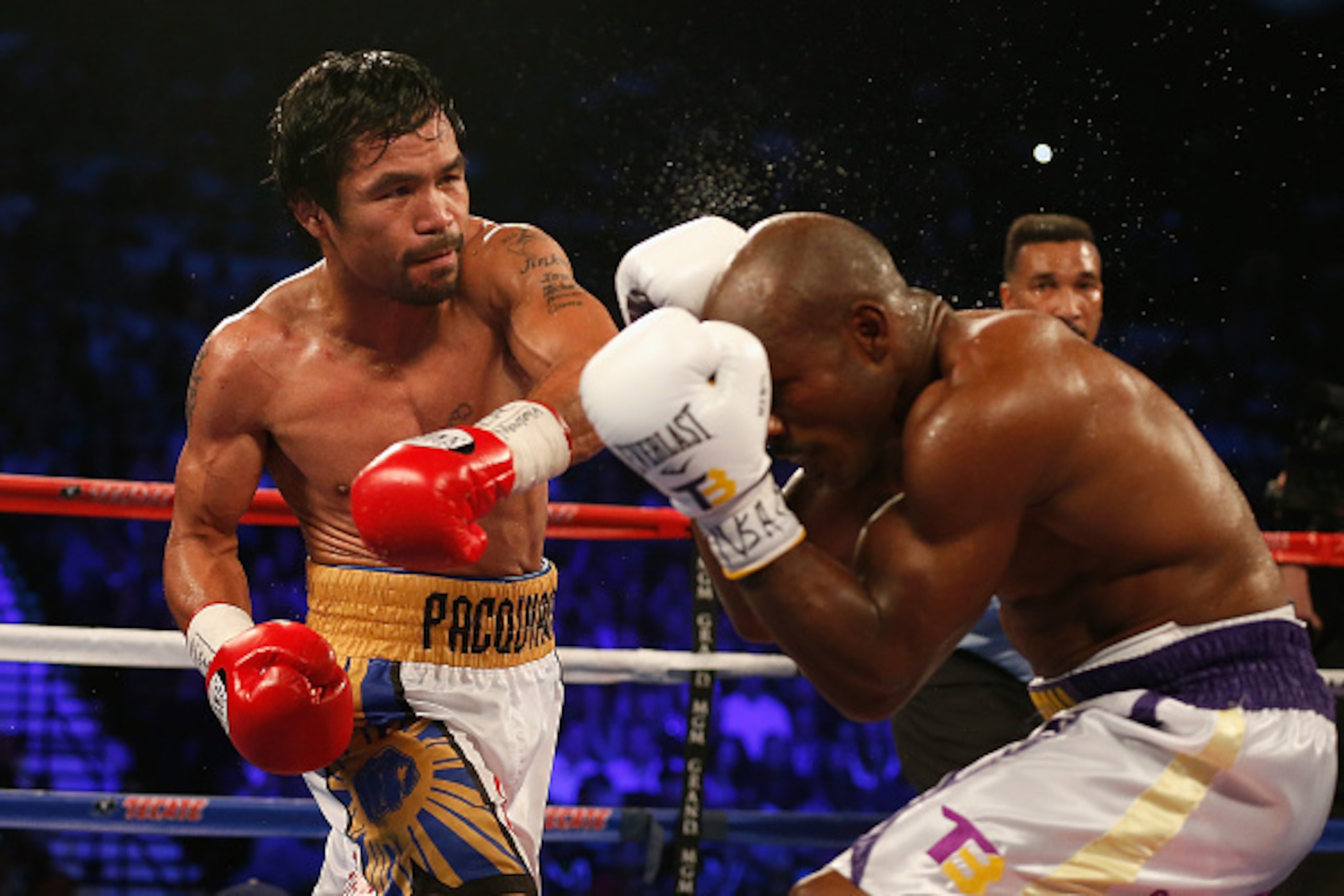 LAS VEGAS, NEVADA - APRIL 09:  Manny Pacquiao (L) throws a left at Timothy Bradley Jr. during their welterweight championship fight on April 9, 2016 at MGM Grand Garden Arena in Las Vegas, Nevada. Manny Pacquiao won by unanimous decision.  (Photo by Chris