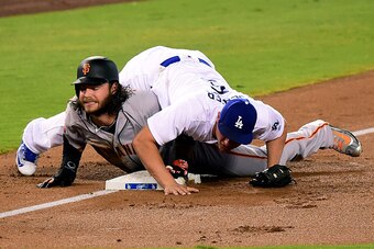 LOS ANGELES, CA - SEPTEMBER 20:  Brandon Crawford #35 of the San Francisco Giants reacts after he is tagged out at third base by Corey Seager #5 of the Los Angeles Dodgers to end the top of the second inning at Dodger Stadium on September 20, 2016 in Los 