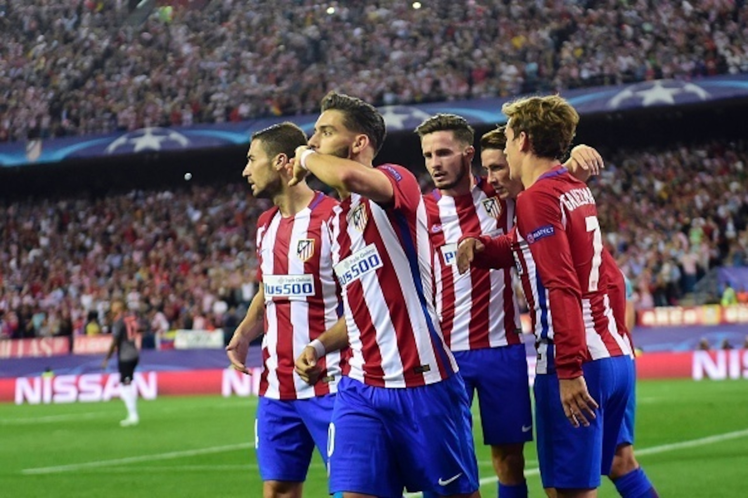 Atletico Madrid's Belgian midfielder Yannick Ferreira Carrasco (2ndL) celebrates with teammates after scoring during the UEFA Champions League Group D football match Club Atletico de Madrid vs FC Bayern Munich at the Vicente Calderon stadium in Madrid on 