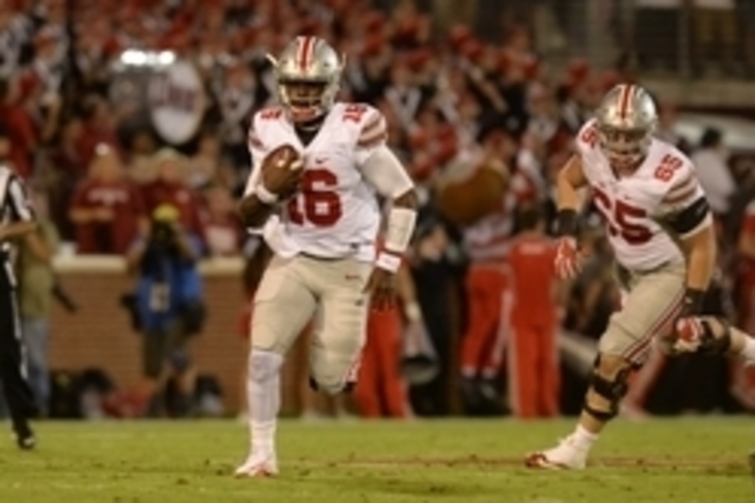 Sep 17, 2016; Norman, OK, USA; Ohio State Buckeyes quarterback J.T. Barrett (16) runs in the open field against the Oklahoma Sooners in the first quarter at Gaylord Family - Oklahoma Memorial Stadium. Mandatory Credit: Mark D. Smith-USA TODAY Sports