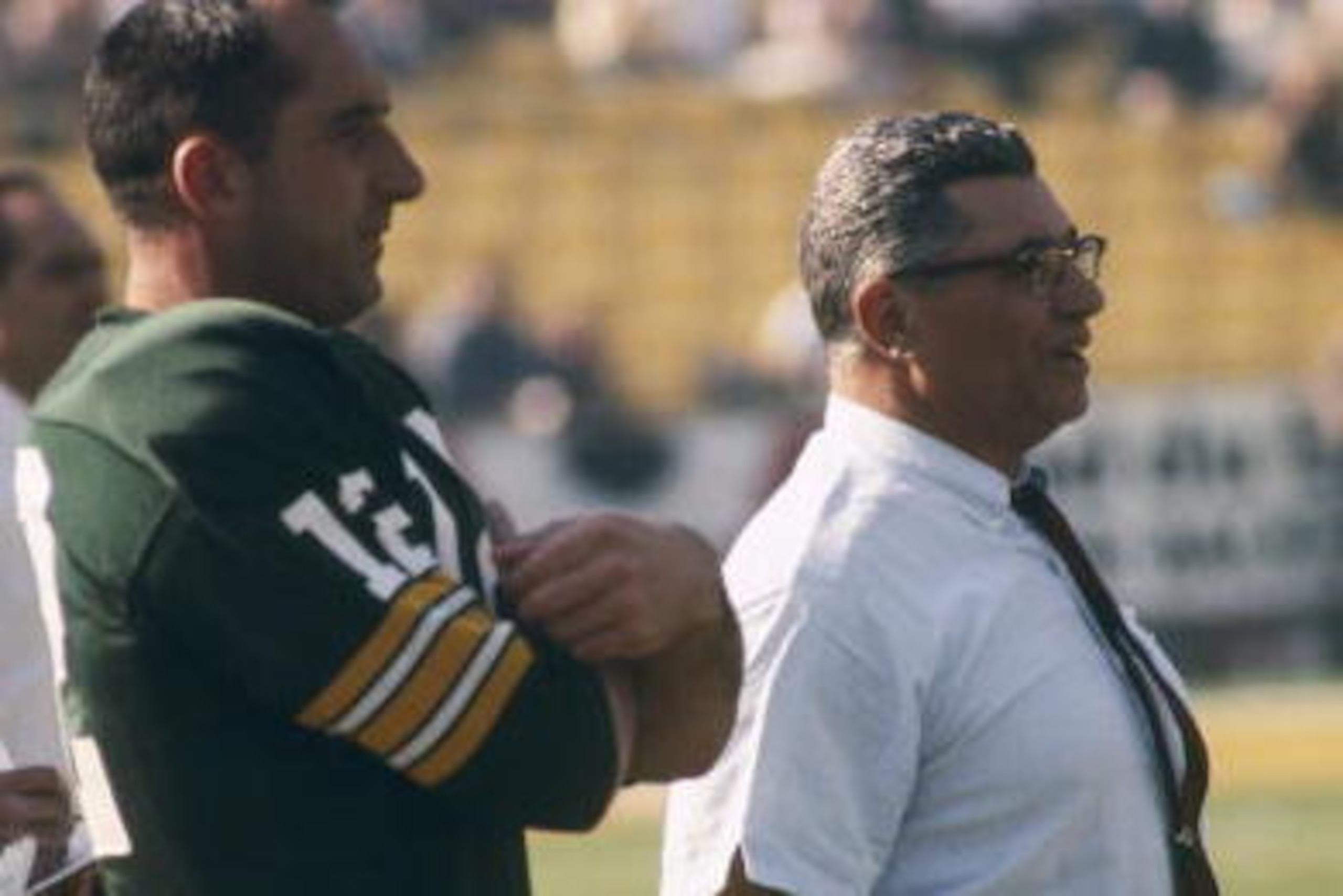 Green Bay Packers Hall of Fame head coach Vince Lombardi adn backup quarterback Zeke Bratkowski (12) watch the team warm up before Super Bowl I, a 35-10 victory over the Kansas City Chiefs on January 15, 1967, at the Los Angeles Memorial Coliseum in Los A