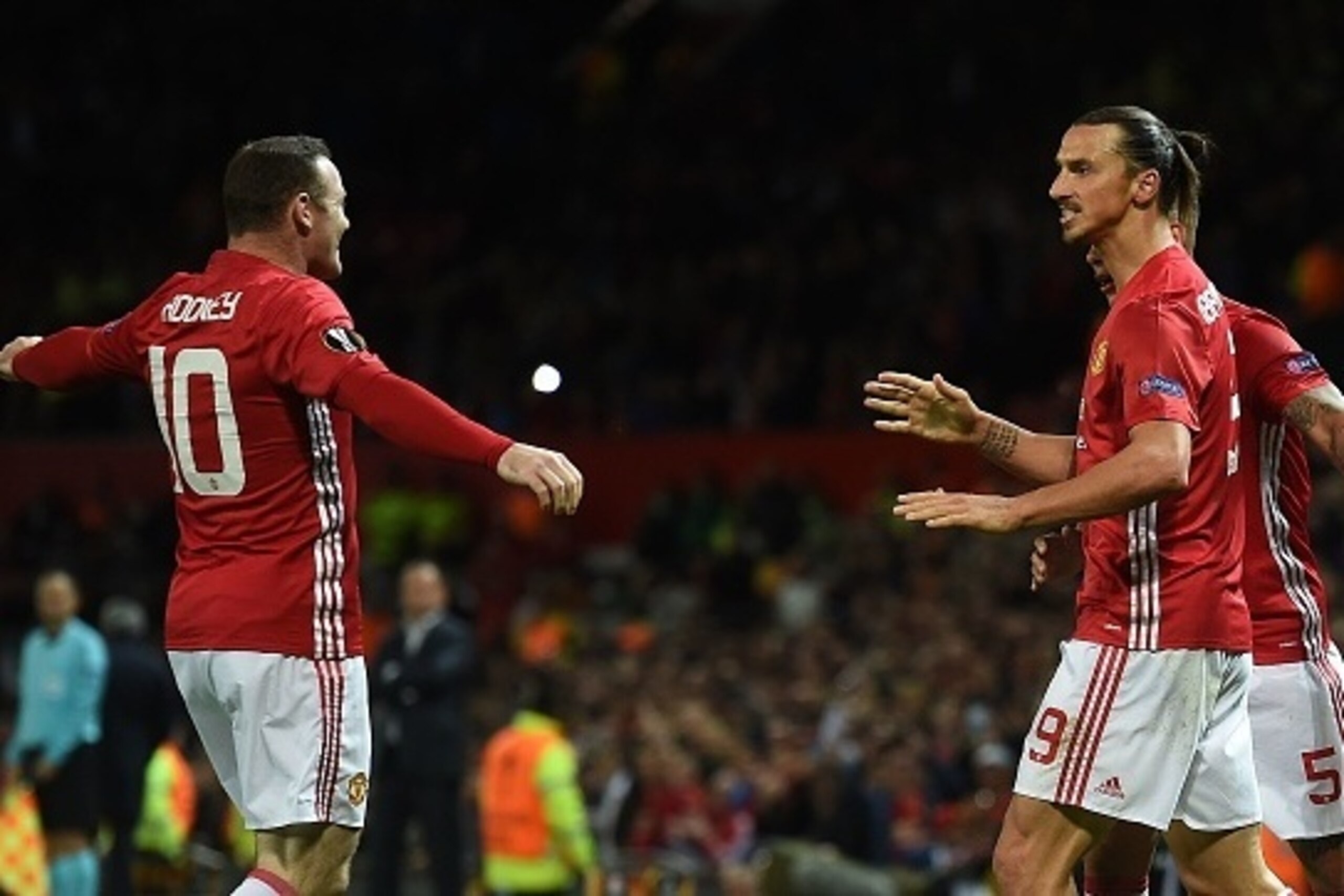 Manchester United's Swedish striker Zlatan Ibrahimovic (R) celebrates scoring his team's first goal with Manchester United's English striker Wayne Rooney (L) during the UEFA Europa League group A football match between Manchester United and Zorya Luhansk 