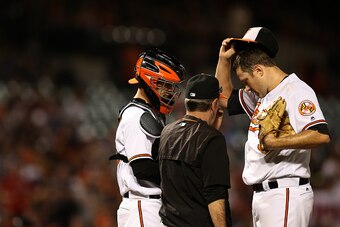BALTIMORE, MD - SEPTEMBER 22: Chris Tillman #30 of the Baltimore Orioles talks with Caleb Joseph #36 and pitching coach Dave Wallace in the second inning against the Boston Red Sox at Oriole Park at Camden Yards on September 22, 2016 in Baltimore, Marylan