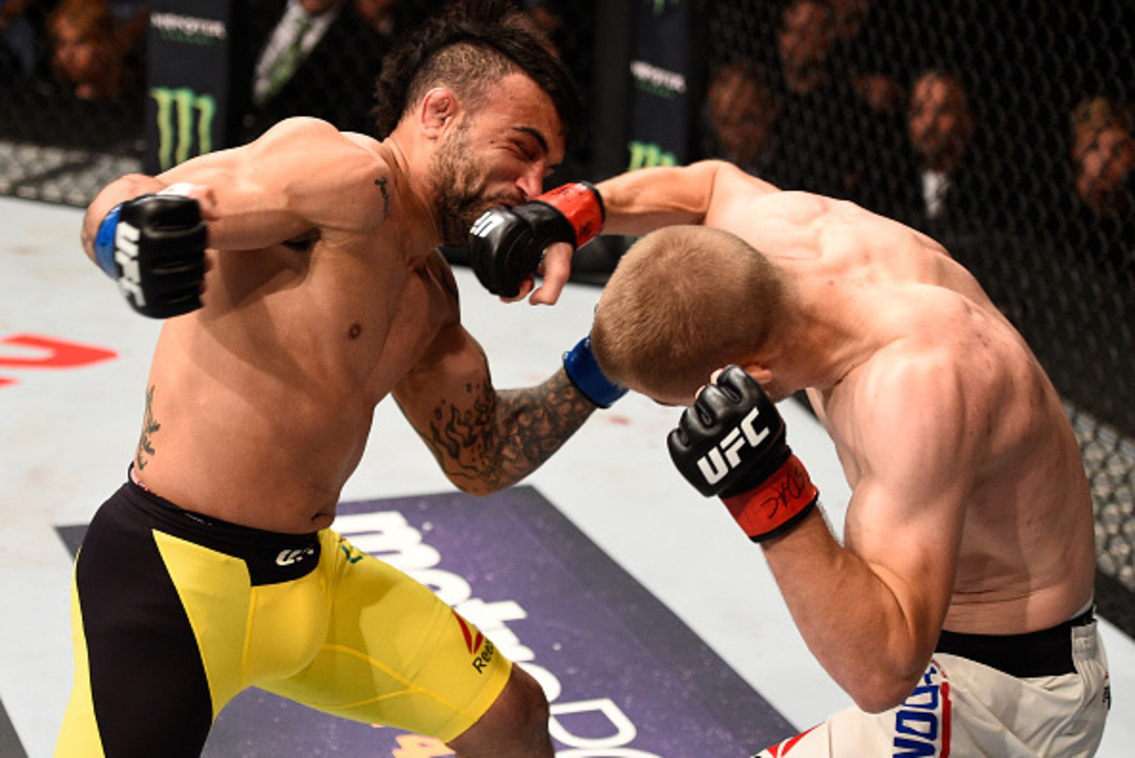 SIOUX FALLS, SD - JULY 13:   (R-L) Michael McDonald punches John Lineker in their bantamweight bout during the UFC Fight Night event on July 13, 2016 at Denny Sanford Premier Center in Sioux Falls, South Dakota. (Photo by Jeff Bottari/Zuffa LLC/Zuffa LLC 