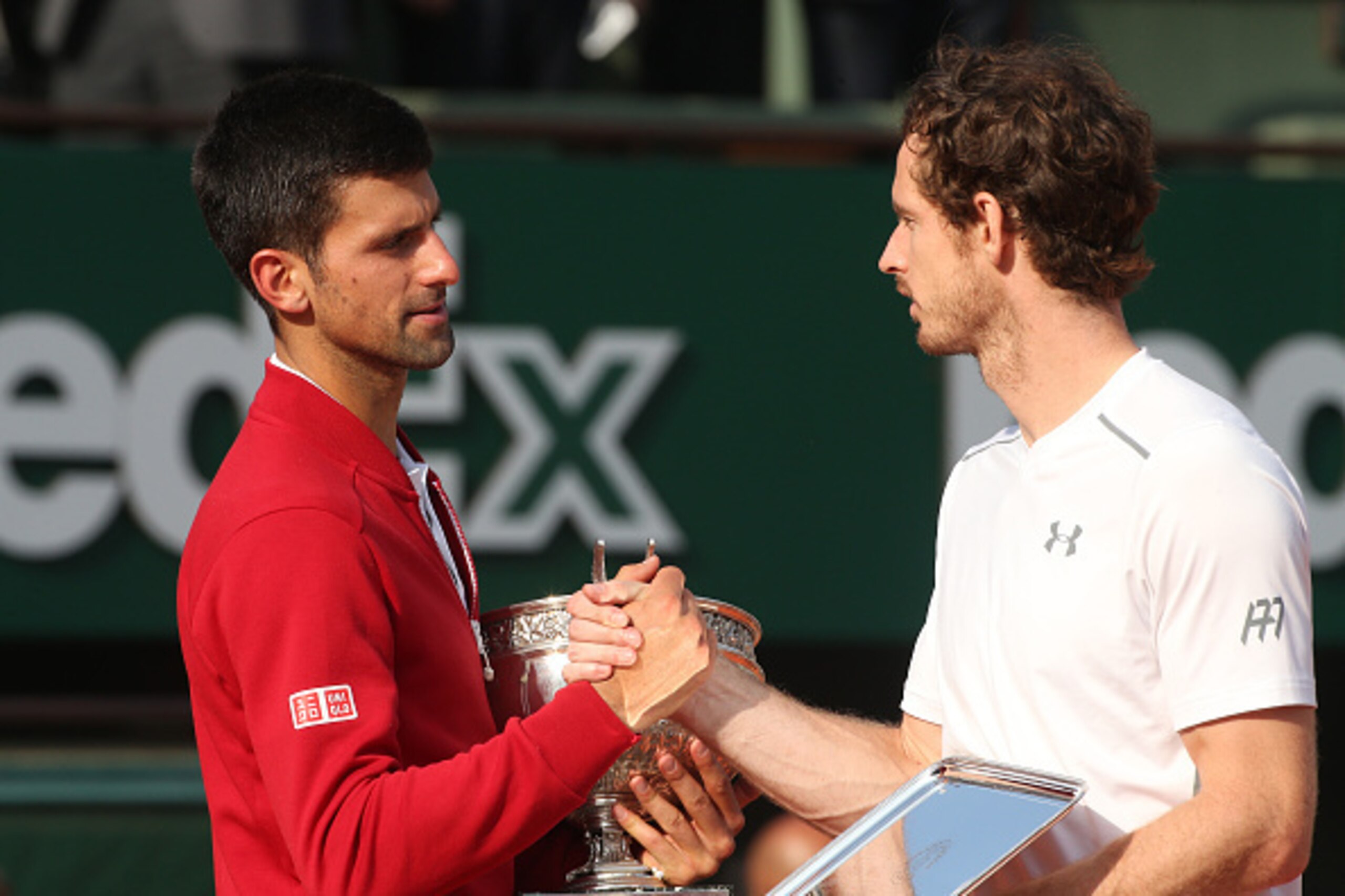 PARIS, FRANCE - JUNE 5: Winner Novak Djokovic of Serbia greets finalist Andy Murray of Great Britain during the trophy ceremony following the Men's Singles final match on day fifteen of the 2016 French Open at Roland-Garros stadium on June 5, 2016 in Pari