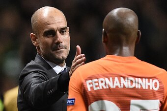 Manchester City's Spanish manager Pep Guardiola (L) congratulates Manchester City's Brazilian midfielder Fernandinho following the UEFA Champions League Group C football match between Celtic and Manchester City at Celtic Park stadium in Glasgow, Scotland 