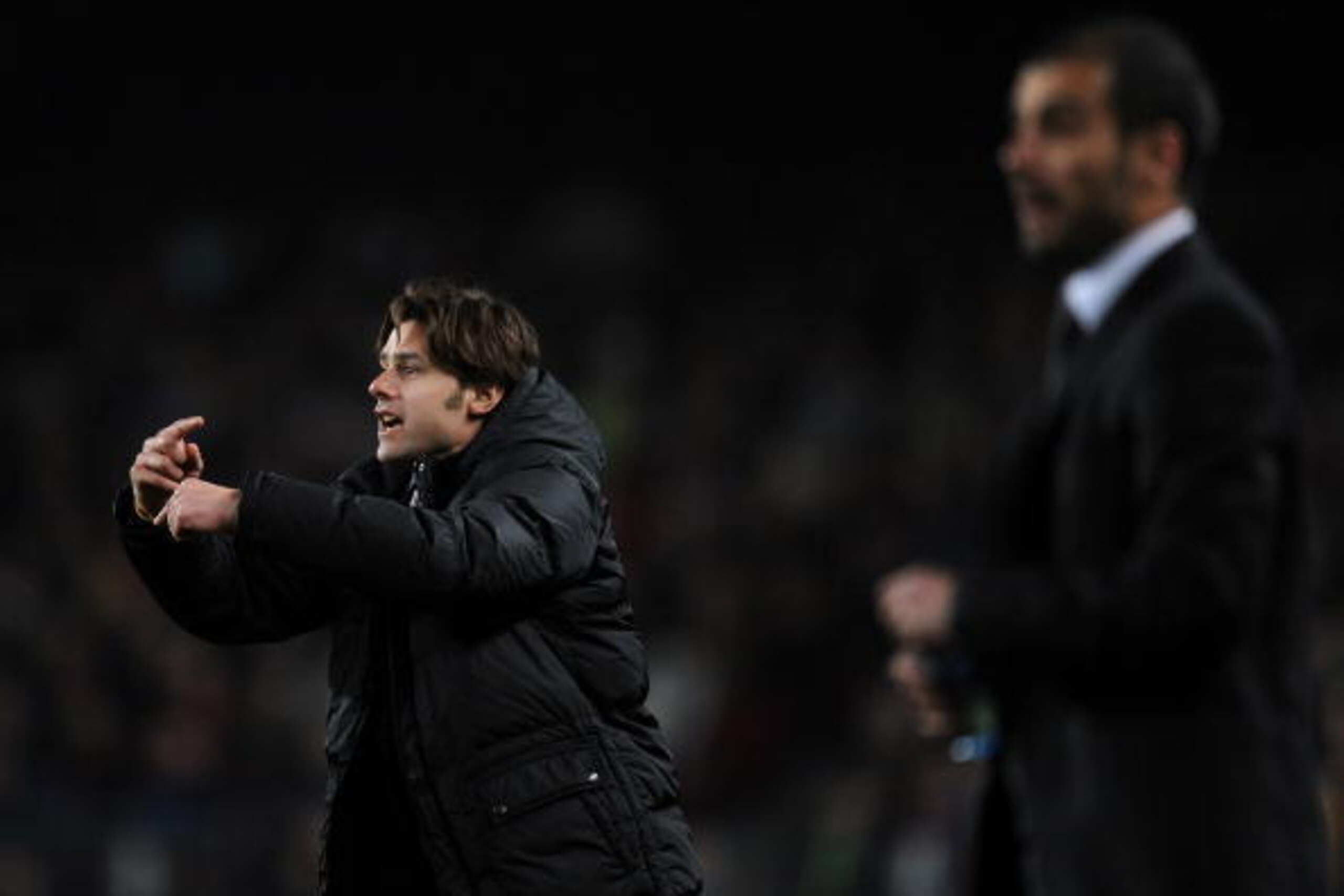 BARCELONA, SPAIN - JANUARY 29:  Coach Mauricio Roberto Pochettino (L) of Espanyol gestures to his players flanked by coach Josep Guardiola of Barcelona during the Copa del Rey quarter final second leg match between Barcelona and Espanyol at the Camp Nou S
