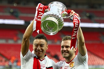 LONDON, ENGLAND - MAY 21:  Goalscorers Jesse Lingard (L) and Juan Mata of Manchester United celebrate with the trophy after winning The Emirates FA Cup Final match between Manchester United and Crystal Palace at Wembley Stadium on May 21, 2016 in London, 