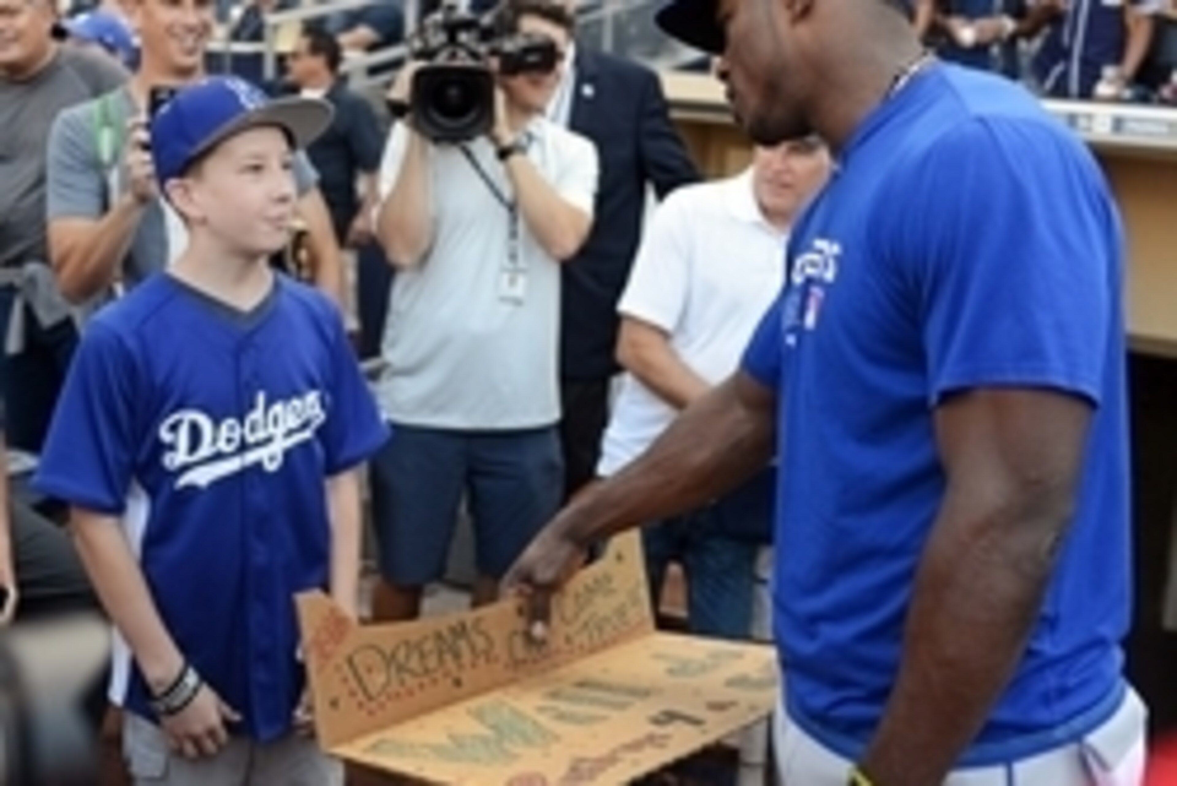 Sep 29, 2016; San Diego, CA, USA; Los Angeles Dodgers right fielder Yasiel Puig (R) meets Noah Rosenberg (L) before he does push-ups for a bat from Puig before the game against the San Diego Padres at Petco Park. Puig pulled him out of the stands after se