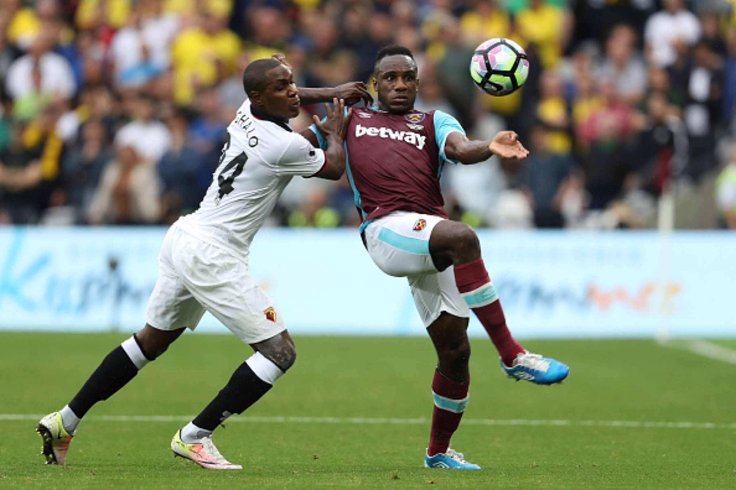 LONDON, ENGLAND - SEPTEMBER 10: Odion Ighalo of Watford (L) and Michail Antonio of West Ham United (R) battle for possession during the Premier League match between West Ham United and Watford at Olympic Stadium on September 10, 2016 in London, England.  