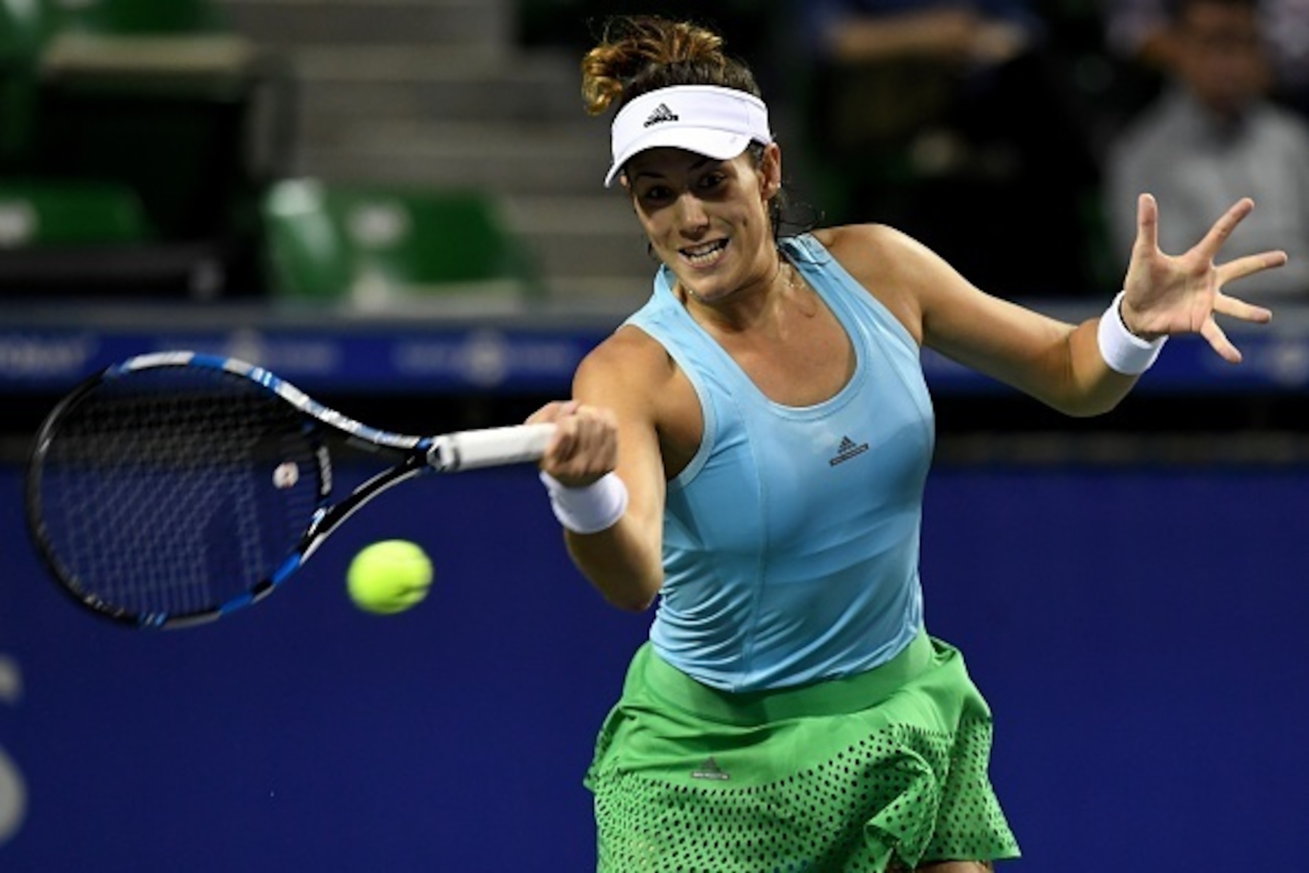 Garbine Muguruza of Spain hits a return against Elina Svitolina of Ukraine during their women's singles quarter-final match at the WTA Pan Pacific Open tennis tournament in Tokyo on September 23, 2016. / AFP / TOSHIFUMI KITAMURA        (Photo credit shoul