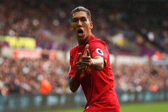 SWANSEA, WALES - OCTOBER 01: Roberto Firmino of Liverpool  celebrates scoring his sides first goal during the Premier League match between Swansea City and Liverpool at Liberty Stadium on October 1, 2016 in Swansea, Wales.  (Photo by Julian Finney/Getty I