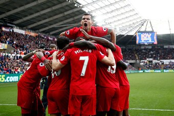 SWANSEA, WALES - OCTOBER 01:  James Milner of Liverpool celebrates scoring his sides second goal with his team mates during the Premier League match between Swansea City and Liverpool at Liberty Stadium on October 1, 2016 in Swansea, Wales.  (Photo by Jul