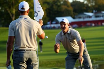 CHASKA, MN - OCTOBER 01: Justin Rose of Europe tosses Henrik Stenson his ball after his chip in on the 16th green during afternoon fourball matches of the 2016 Ryder Cup at Hazeltine National Golf Club on October 1, 2016 in Chaska, Minnesota.  (Photo by A