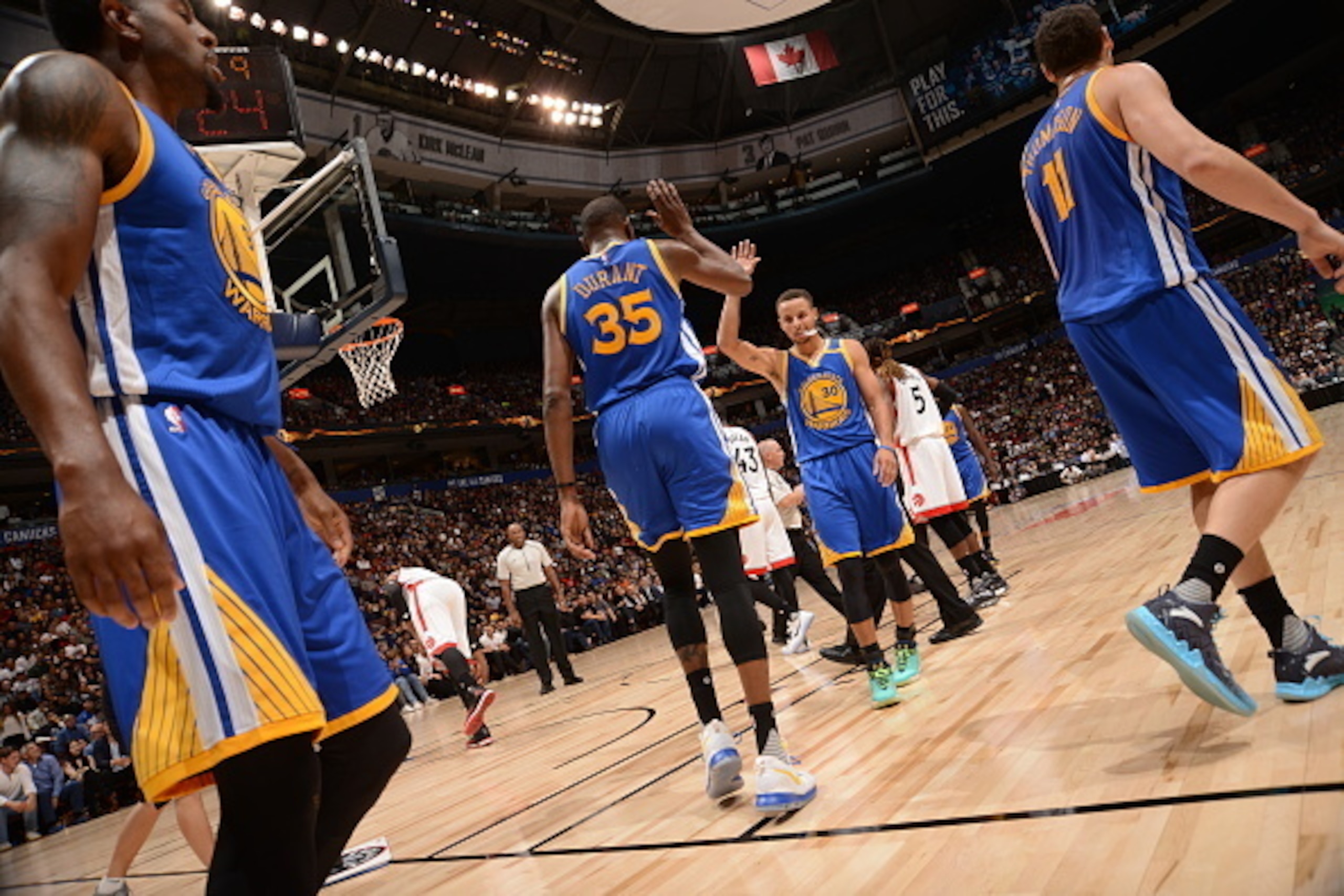 VANCOUVER, BC - OCTOBER 1:  Stephen Curry #30 of the Golden State Warriors high fives Kevin Durant #35 during the game against the Toronto Raptors during a preseason game on October 1, 2016 at Rogers Arena in Vancouver, British Columbia, Canada. NOTE TO U