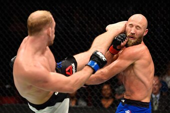 PORTLAND, OR - OCTOBER 01:  (L-R) Zak Ottow lands a head kick against Joshua Burkman in their welterweight bout during the UFC Fight Night event at the Moda Center on October 1, 2016 in Portland, Oregon. (Photo by Josh Hedges/Zuffa LLC/Zuffa LLC via Getty