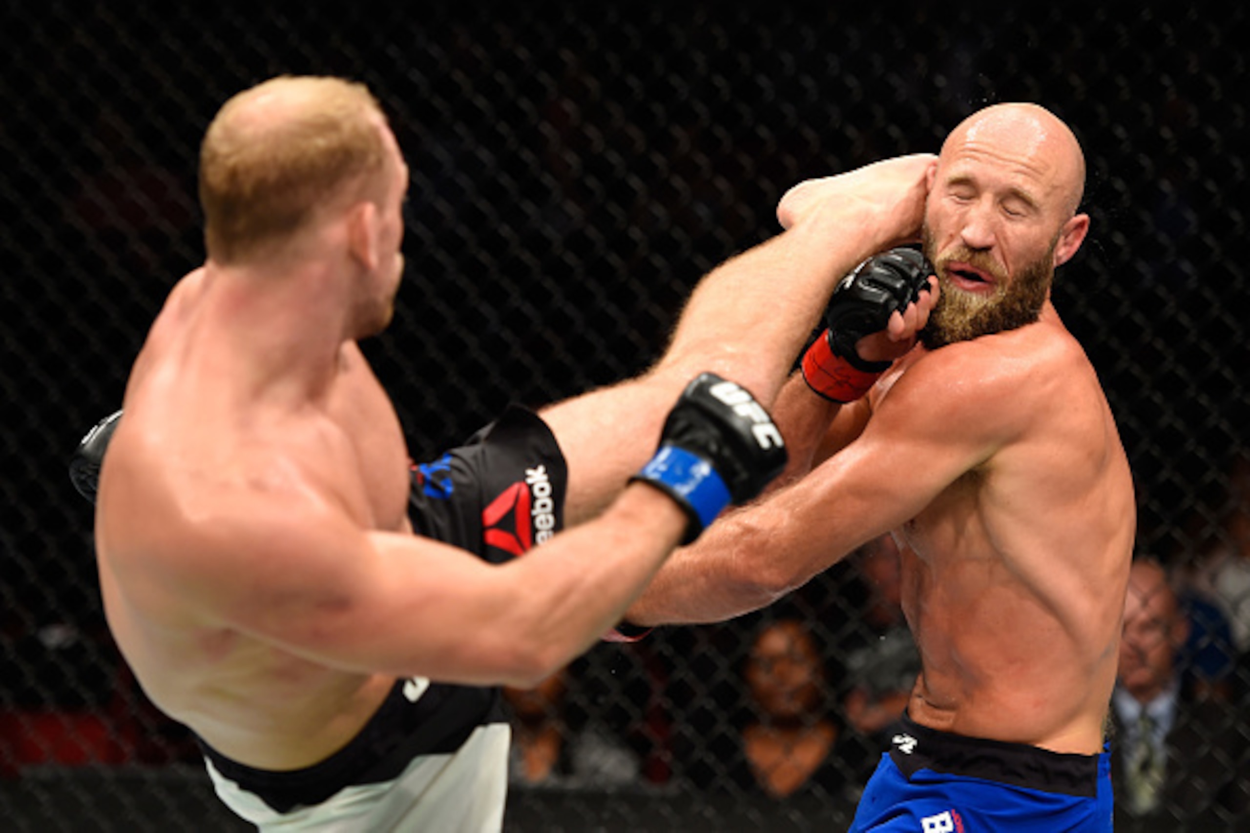 PORTLAND, OR - OCTOBER 01:  (L-R) Zak Ottow lands a head kick against Joshua Burkman in their welterweight bout during the UFC Fight Night event at the Moda Center on October 1, 2016 in Portland, Oregon. (Photo by Josh Hedges/Zuffa LLC/Zuffa LLC via Getty
