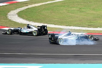 Mercedes AMG Petronas F1 Team's German driver Nico Rosberg spins (R) out of control after being clipped by Scuderia Ferrari's German driver Sebastian Vettel (not pictured) as Mercedes AMG Petronas F1 Team's British driver Lewis Hamilton (L) drives pass du