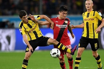 Dortmund's midfielder Christian Pulisic (L) and Leverkusen's Chilean midfielder Charles Aranguiz vie for the ball during the German first division Bundesliga football match between Bayer 04 Leverkusen and BVB Borussia Dortmund in the Bay Arena in Leverkus