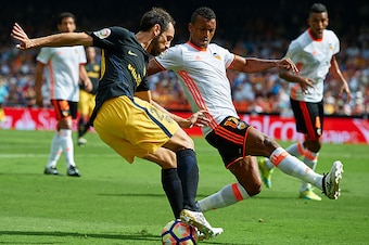 VALENCIA, SPAIN - OCTOBER 02:  Nani (R) of Valencia competes for the ball with Juanfran Torres of Atletico de Madrid during the La Liga match between Valencia CF and Atletico de Madrid at Mestalla Stadium on October 02, 2016 in Valencia, Spain.  (Photo by