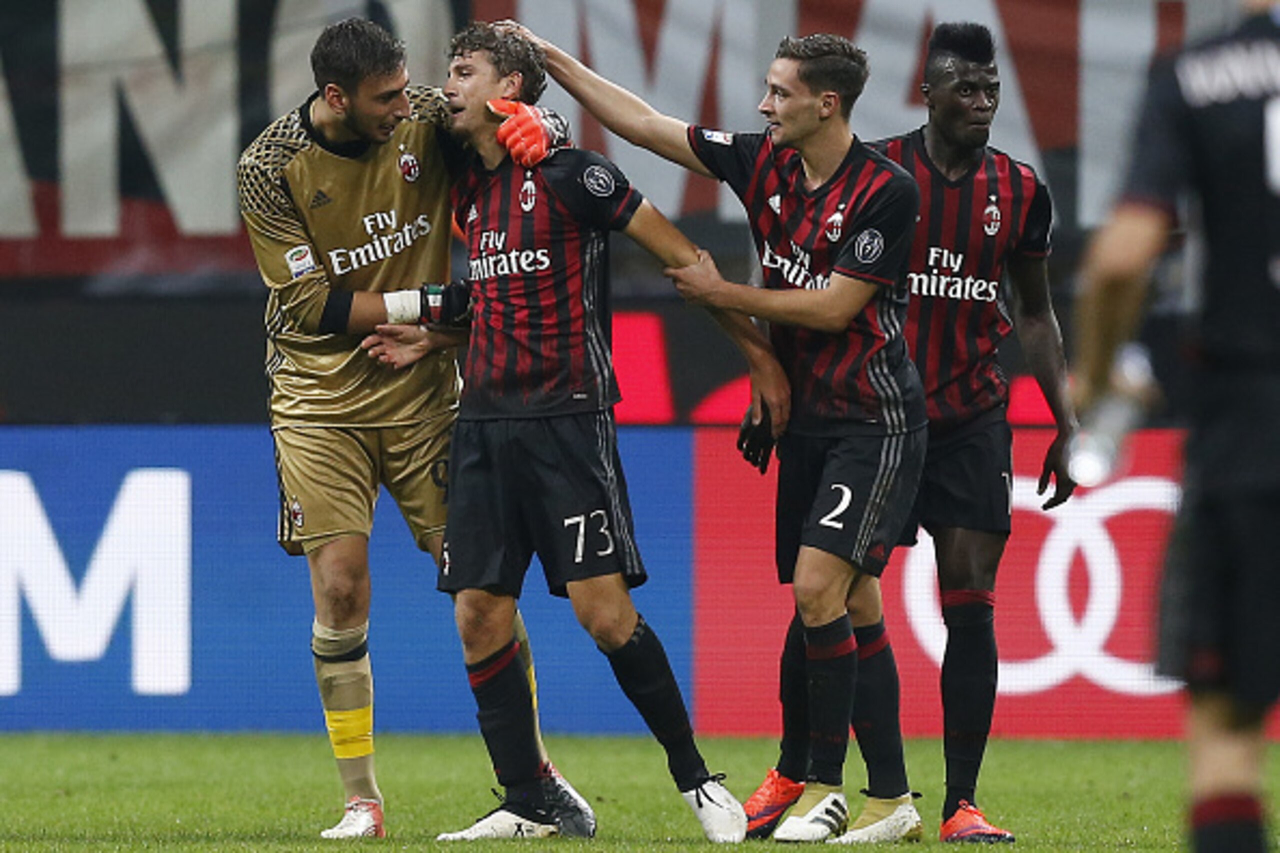AC Milan's midfielder Manuel Locatelli (2ndL) celebrates with teammates after scoring during the Italian Serie A football match AC Milan vs Sassuolo on October 2, 2016 at the San Siro stadium in Milan.  / AFP / MARCO BERTORELLO        (Photo credit should