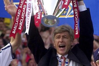 LONDON, UNITED KINGDOM:  Arsenal's coach Arsene Wenger celebrates at Arsenal soccer ground in London 11 May 2002 after beating Everton 4-3. Arsenal won the F.A Barclaycard Premiership Trophy. AFP PHOTO Nicolas ASFOURI. (Photo credit should read NICOLAS AS