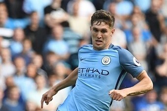 Manchester City's English defender John Stones runs with the ball during the English Premier League football match between Manchester City and Bournemouth at the Etihad Stadium in Manchester, north west England, on September 17, 2016. / AFP / PAUL ELLIS /