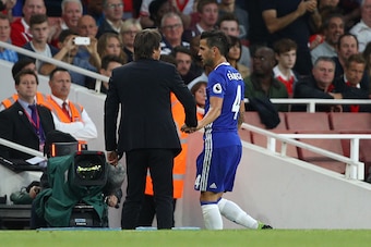 LONDON, ENGLAND - SEPTEMBER 24: Cesc Fabregas of Chelsea (R) speaks to Antonio Conte, Manager of Chelsea (L) after being subbed during the Premier League match between Arsenal and Chelsea at the Emirates Stadium on September 24, 2016 in London, England.  