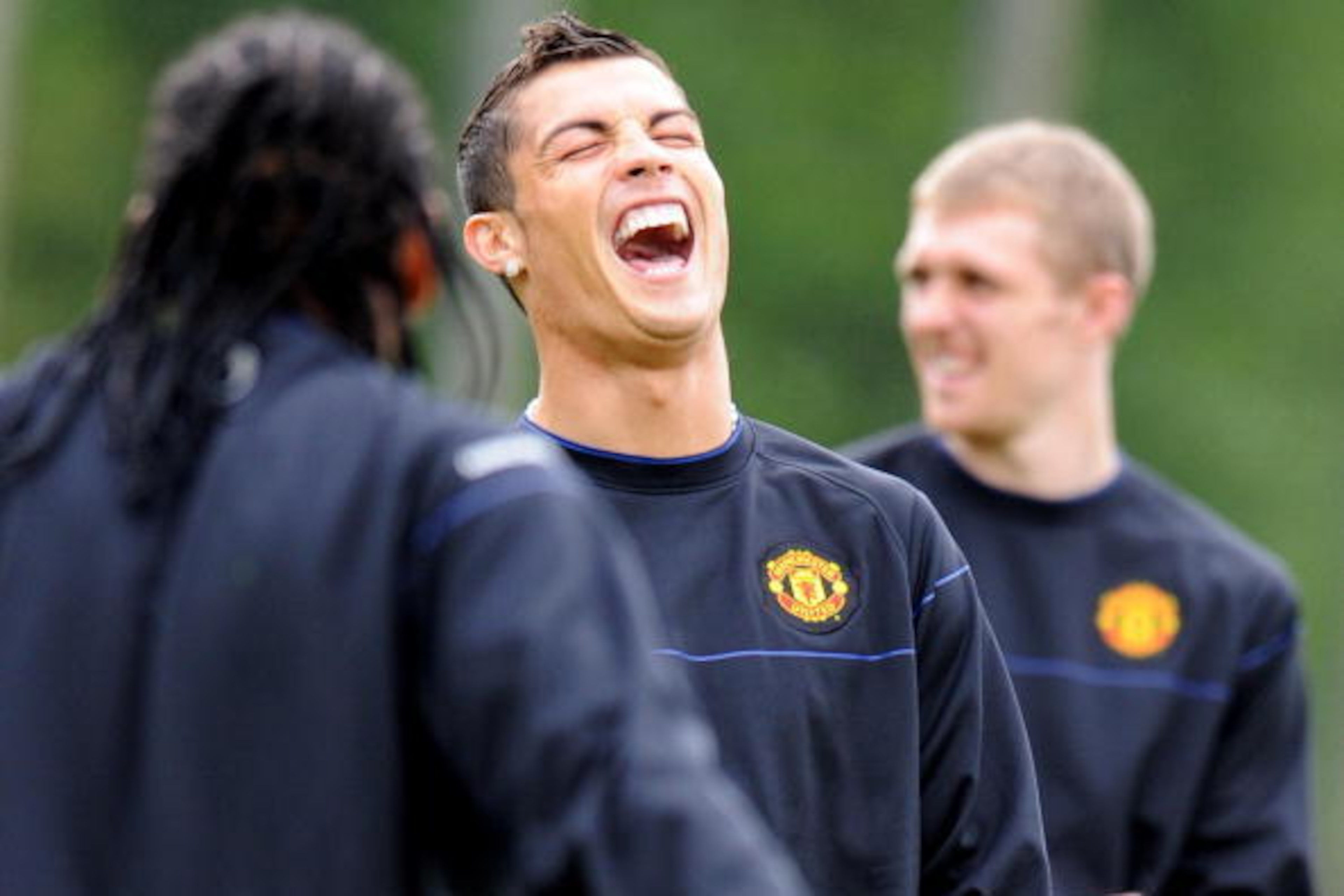 Manchester United's Portugese midfielder Cristiano Ronaldo (C) laughs during a training session at their Carrington training ground in Manchester, north-west England, on April 28, 2009. Manchester United take on Arsenal in the first leg of their UEFA Cham