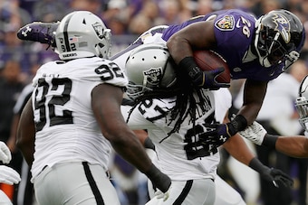 BALTIMORE, MD - OCTOBER 02: Reggie Nelson #27 of the Oakland Raiders tackles  Terrance West #28 of the Baltimore Ravens in the first half at M&T Bank Stadium on October 2, 2016 in Baltimore, Maryland.  (Photo by Rob Carr/Getty Images)
