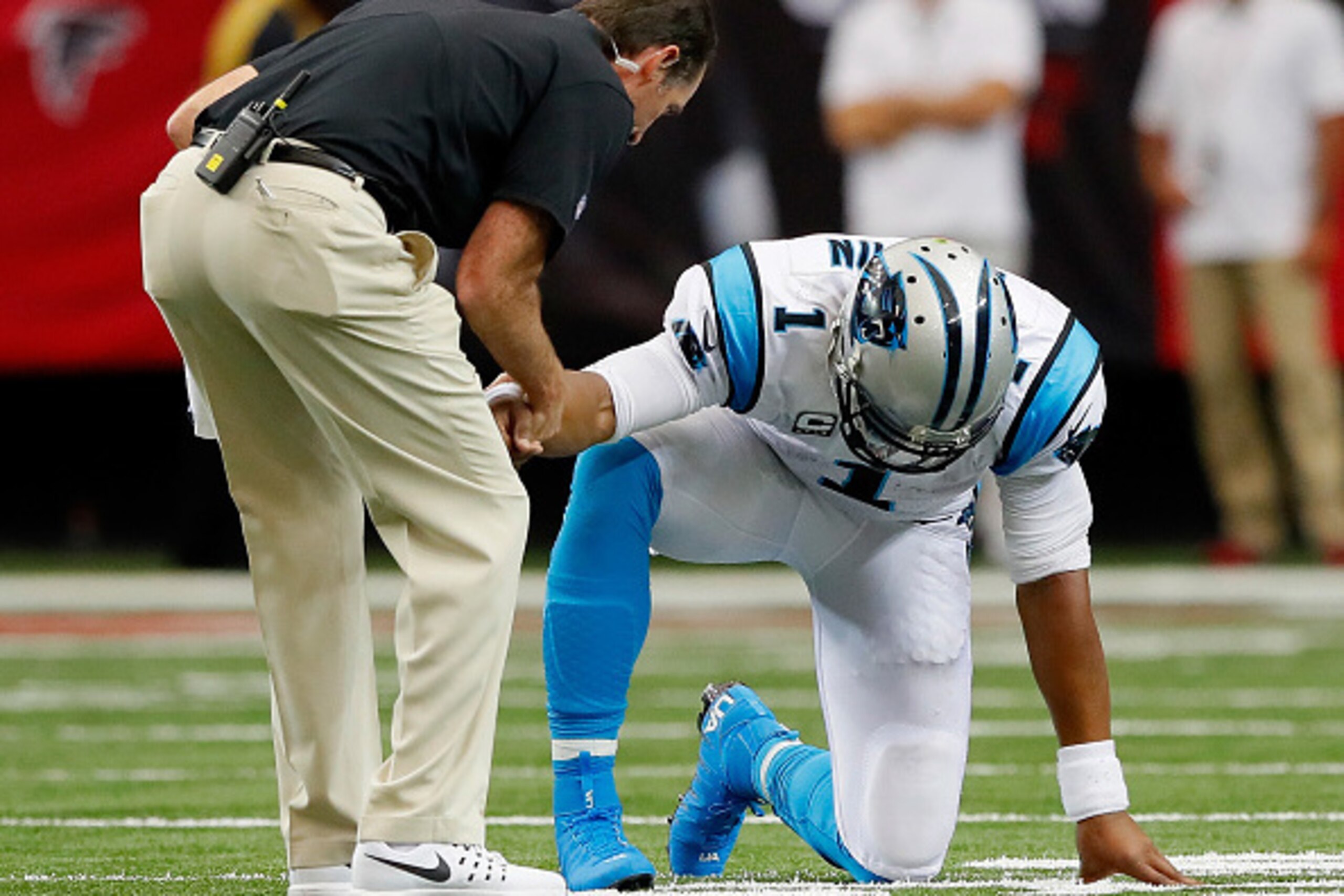 ATLANTA, GA - OCTOBER 02:  Cam Newton #1 of the Carolina Panthers is worked on by a trainer during a timeout after taking a hit on a rush against the Atlanta Falcons at Georgia Dome on October 2, 2016 in Atlanta, Georgia.  (Photo by Kevin C. Cox/Getty Ima