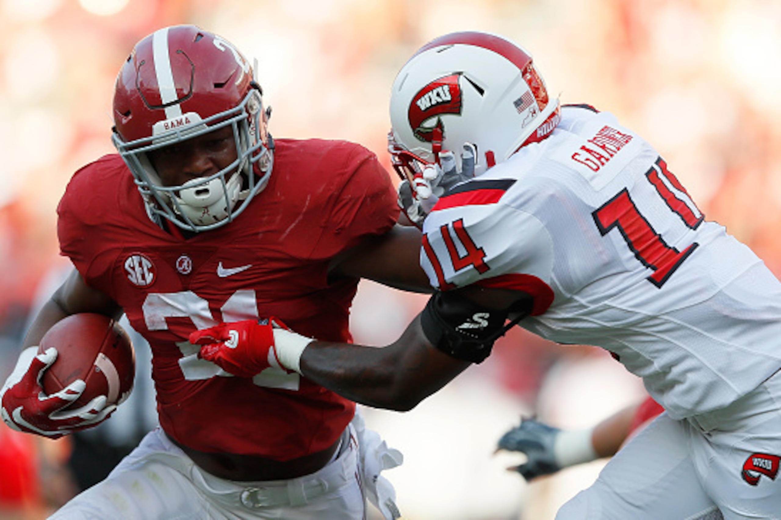 TUSCALOOSA, AL - SEPTEMBER 10:  B.J. Emmons #21 of the Alabama Crimson Tide stiff arms Juwan Gardner #14 of the Western Kentucky Hilltoppers at Bryant-Denny Stadium on September 10, 2016 in Tuscaloosa, Alabama.  (Photo by Kevin C. Cox/Getty Images)