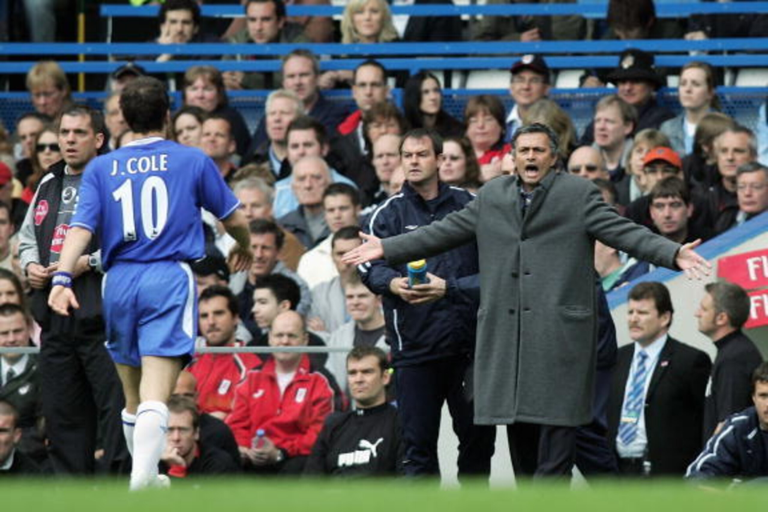 LONDON - APRIL 23:  Joe Cole of Chelsea walks over to the bench to listen to Manager, Jose Mourinho after scoring the first goal of the game during the Barclays Premiership match between Chelsea and Fulham at Stamford Bridge on April 23, 2005 in London, E