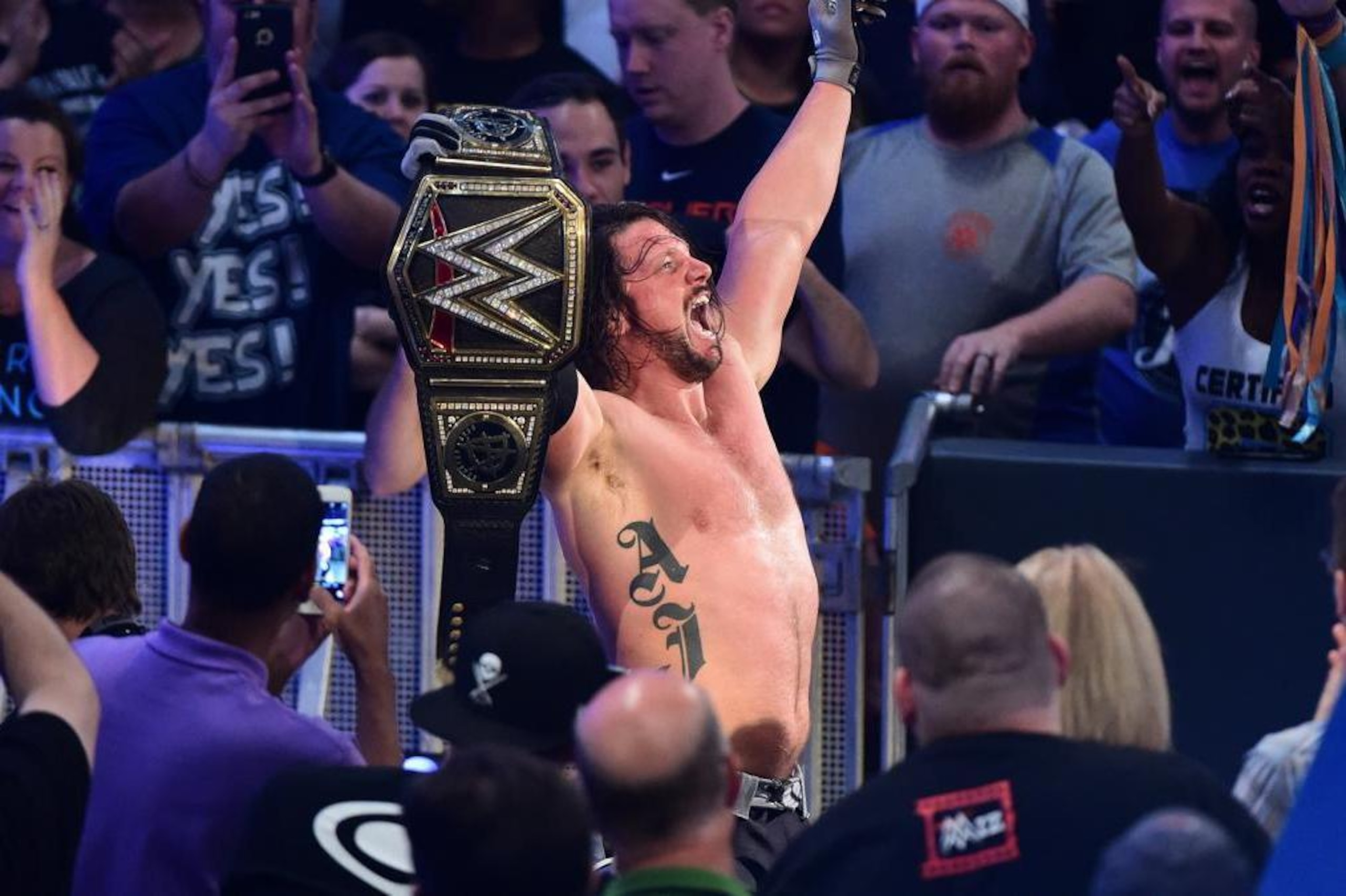 AJ Styles celebrates winning the WWE World Championship.