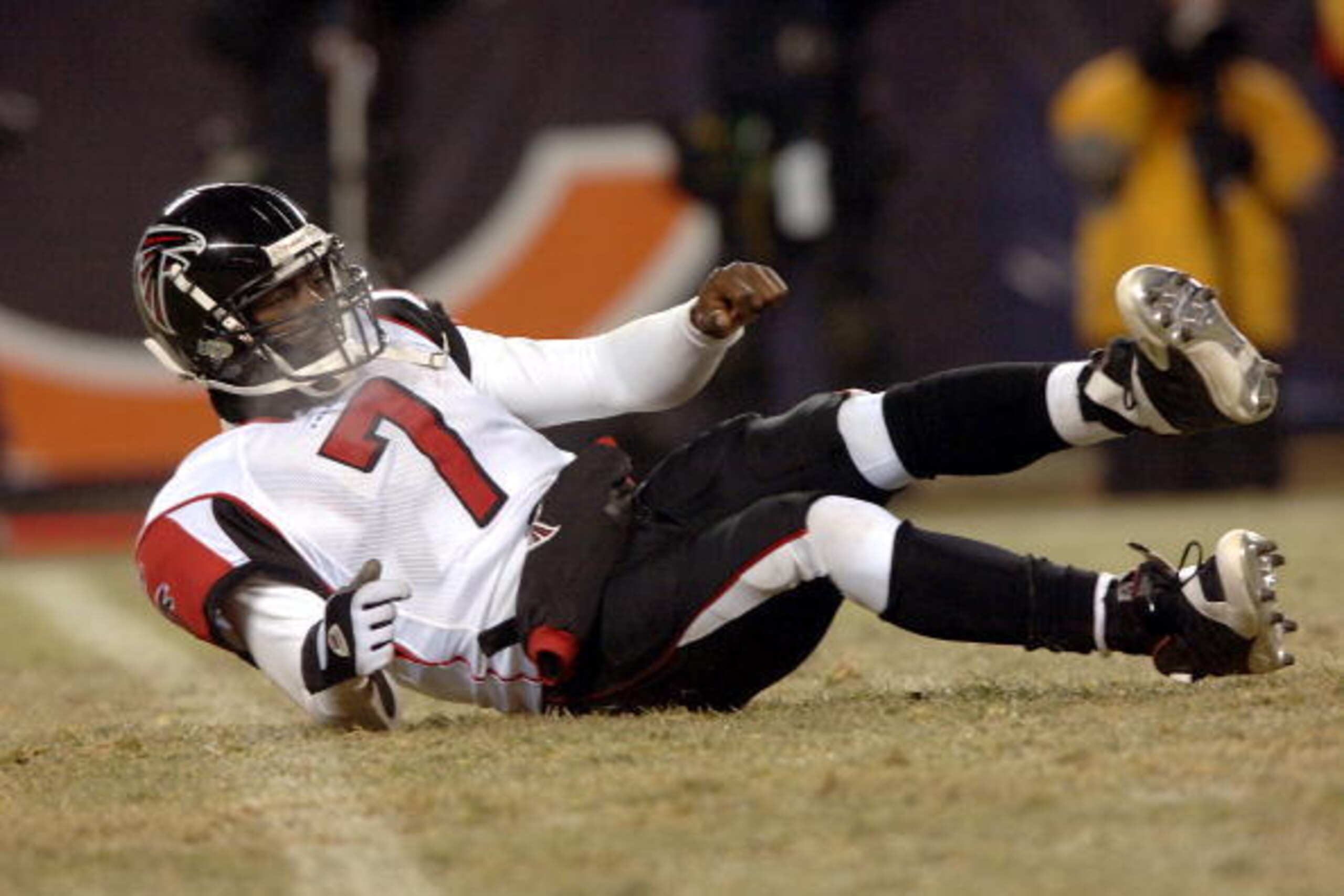 Michael Vick #7 of the Atlanta Falcons lies on the turf after he was sacked in the second half of their against the The Chicago Bears at Soldier Field December 18, 2005 in Chicago, Illinois. The Bears defeated the Falcons 16-3. (Photo by Steve Grayson/Get